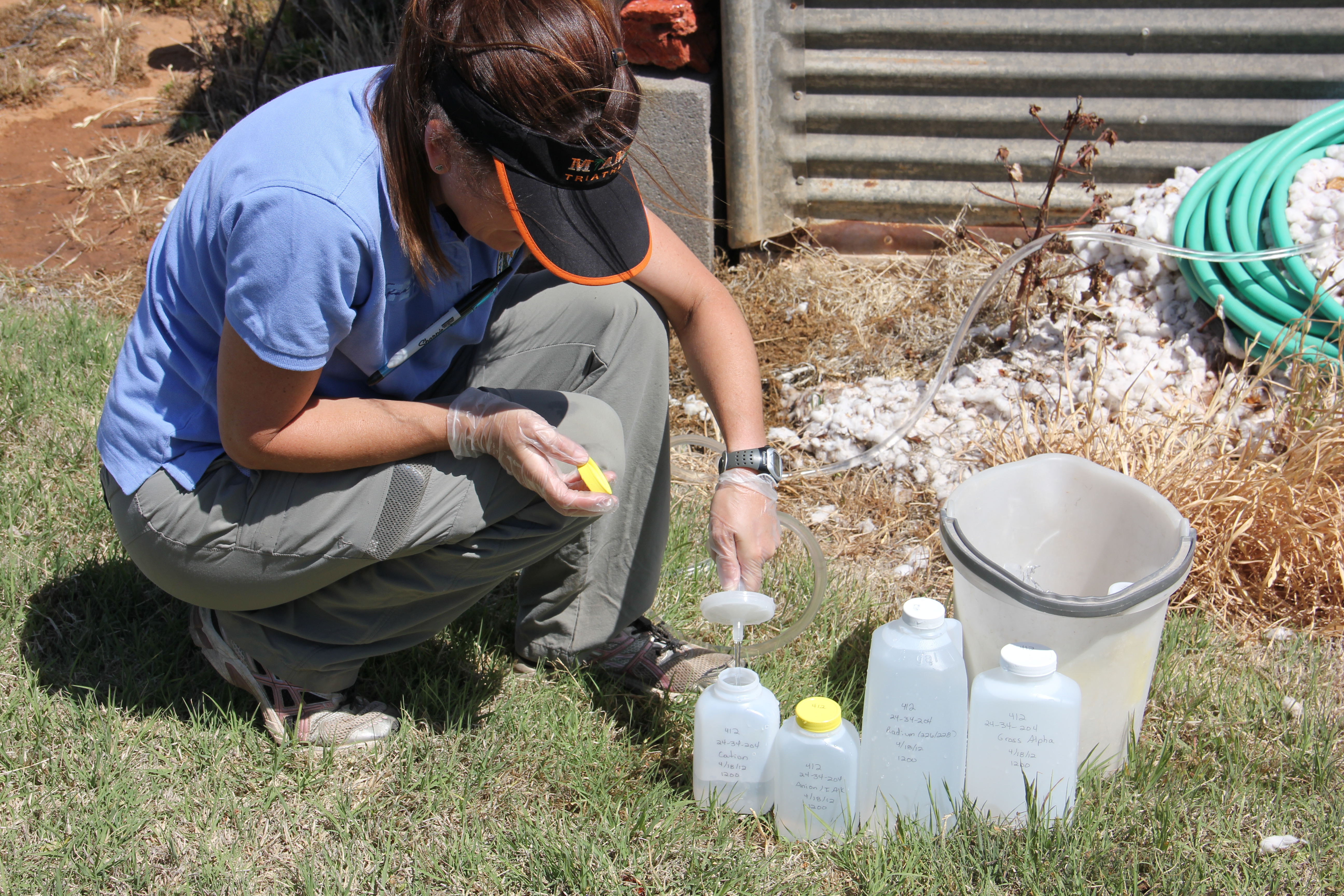 Image of staff filling sample bottles at a well