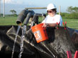 Anna Hoag, BuRec Oklahoma-Texas Area Office Student Intern, prepares to verify concentrate flow: from left to right, UF retentate, RO permeate, RO concentrate.