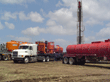 Cement and water transport trucks preparing to set surface casing