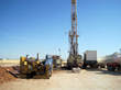 Cuttings sump, shaker table, drill rig, storage trailer, and tank truck