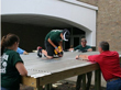 Students installing the corrugated metal roof for the rainwater harvesting system.