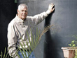 Billy in front of one of the cisterns at his home in Menard, TX.