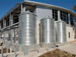 Close-up view of 6,500-gallon tanks, piping and roof