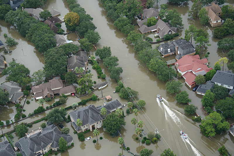 Two boats running on the flooded road from Hurricane Harvey in Houston.