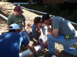 Rain Team members receiving instruction from Billy on gluing PVC pipe.