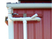 Roof gutter, Y valve connector and downspout on barn